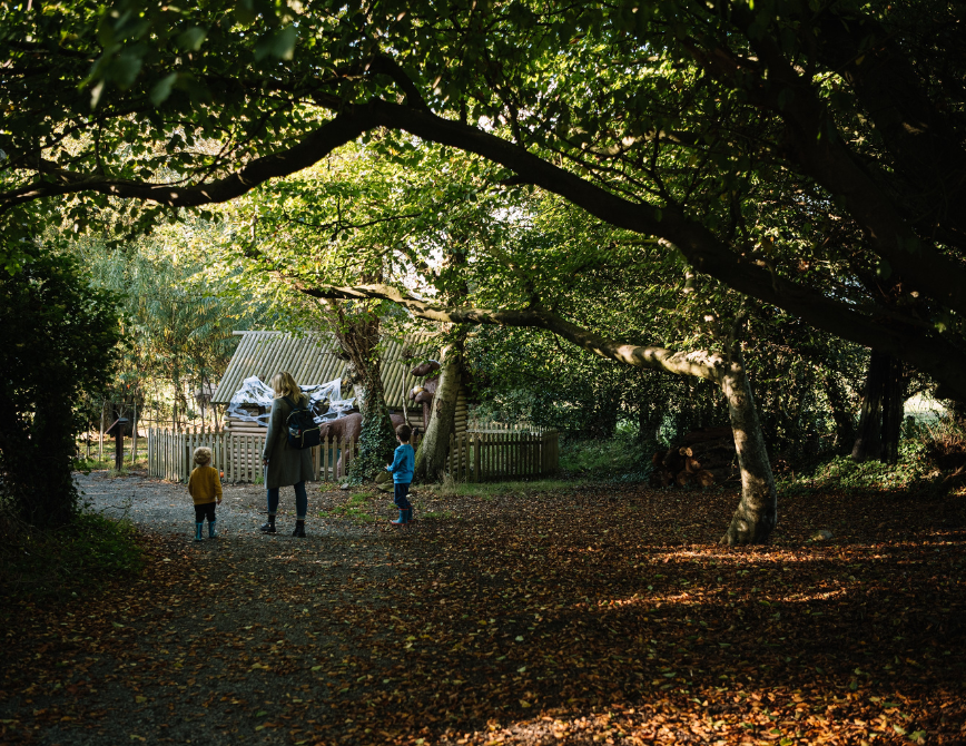 A woman and two children exploring the Ark Farm Fairytale Forest